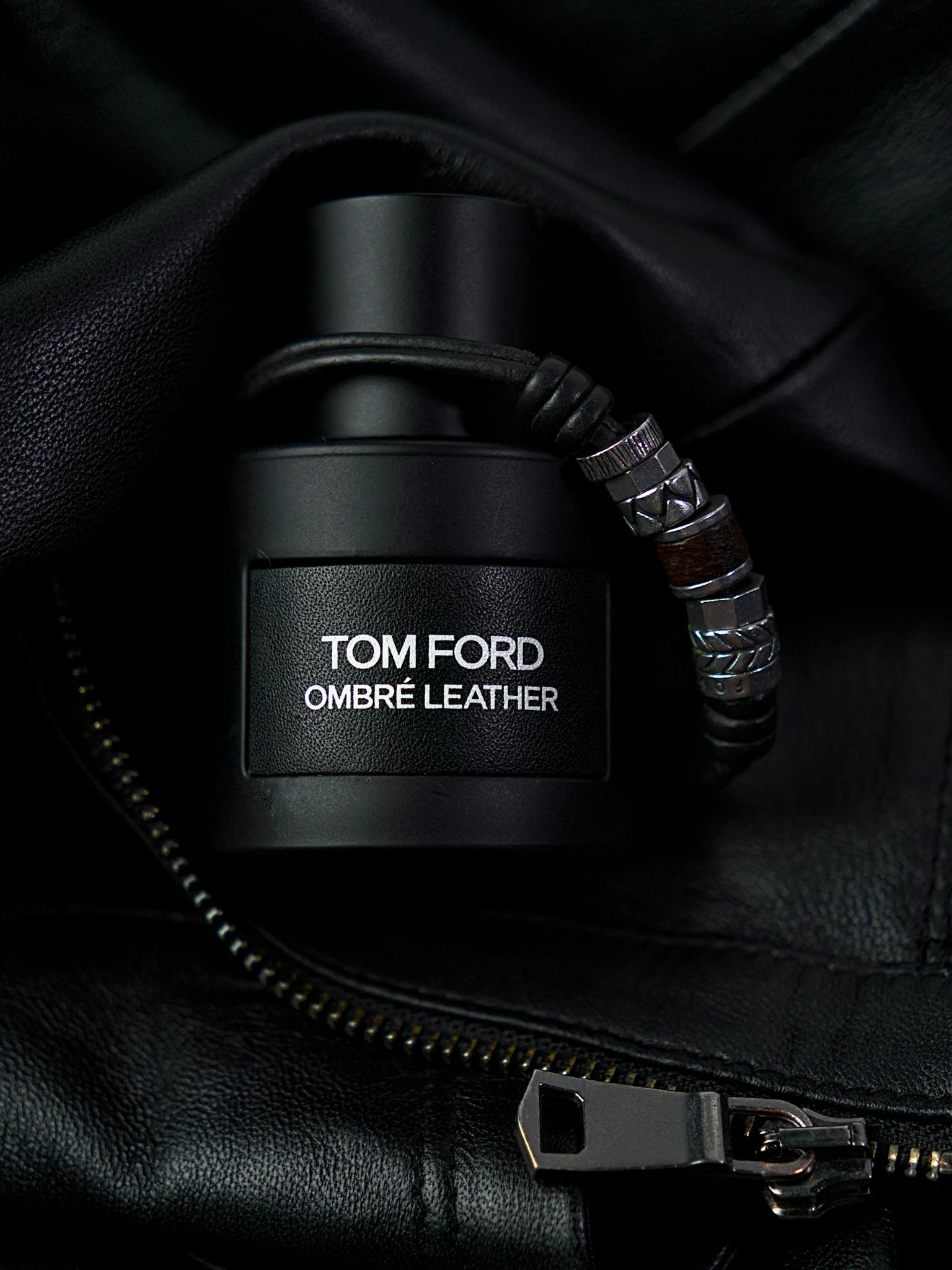 Tom Ford Ombré Leather fragrance bottle surrounded by luxurious black leather.